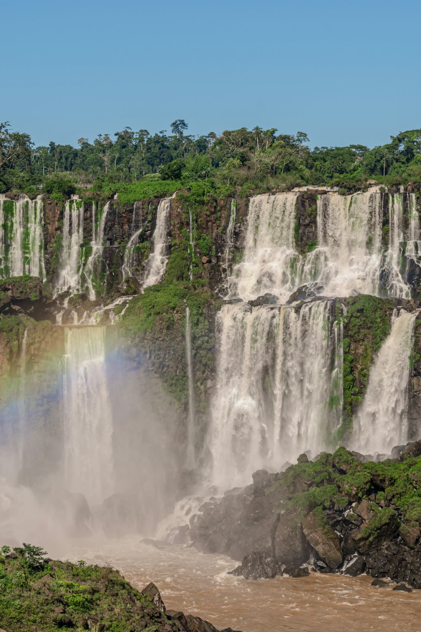 Waterfalls and rainbow over basalt cliffs